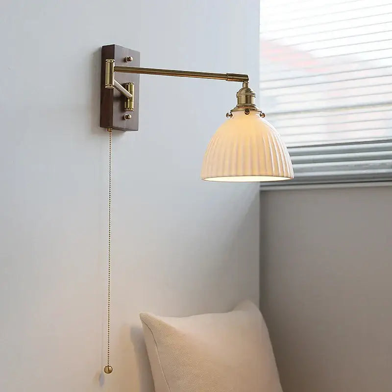 Adjustable brass wall sconce with ribbed glass shade bedroom light