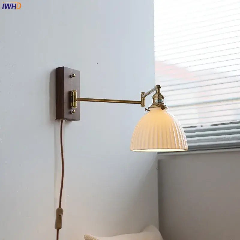 Adjustable brass wall sconce with ribbed glass shade bedroom light