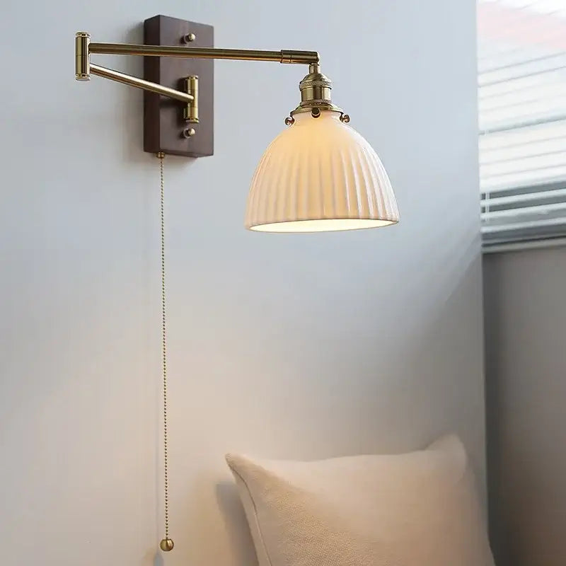 Adjustable brass wall sconce with ribbed glass shade bedroom light