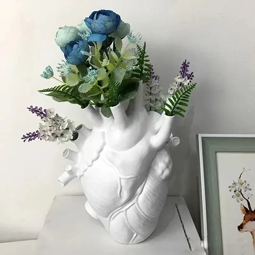 Decorbites™ anatomical heart resin vase in white filled with blue, green, and purple artificial flowers for glam decor