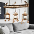 DecorBites antique brass lantern pendant with three clear glass lights, bird accent, and bulb base in rustic coastal style