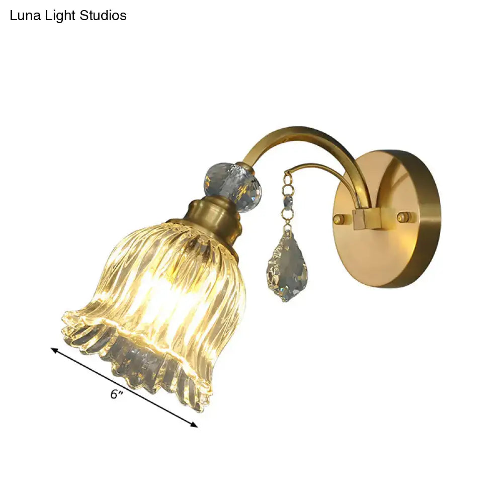 Antique brass gold-toned flower wall sconce with fluted glass shade and crystal accents for living room decor