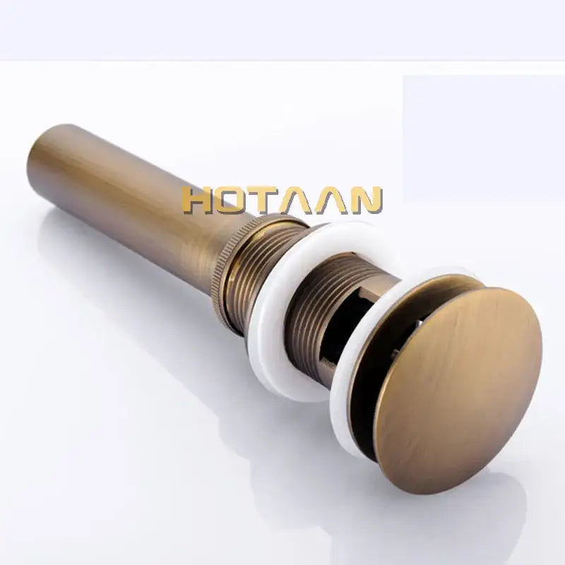 Antique brass sink drain with white rubber seal – bathroom waste