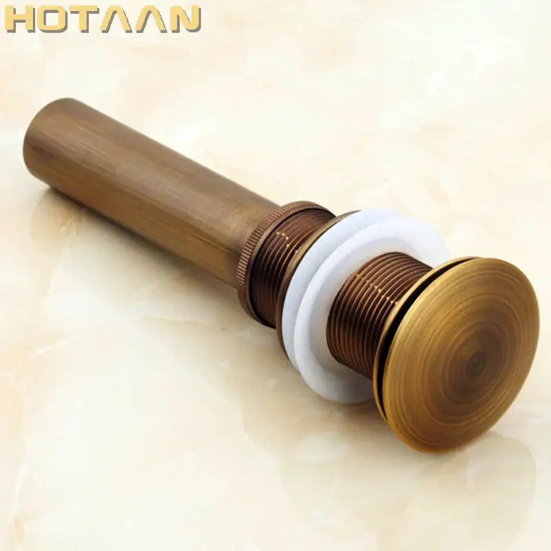 Antique brass sink drain with white rubber seal – bathroom waste