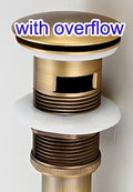 Antique brass sink drain with white rubber seal – bathroom waste