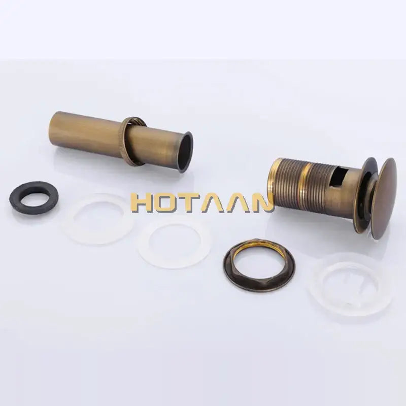 Antique brass sink drain with white rubber seal – bathroom waste