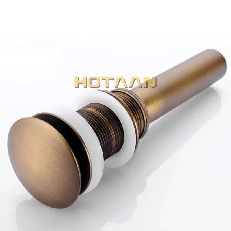 Antique brass sink drain with white rubber seal – bathroom waste