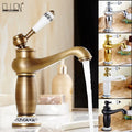 Antique bronze decorbites single handle bathroom faucet with brass finish and white ceramic handle with black detailing real shot details