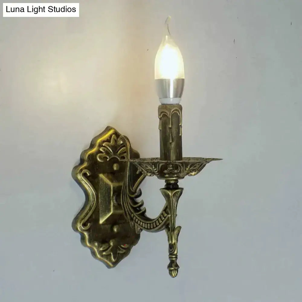 Antique gold retro european wall light brass candlestick-style sconce with ornate scrollwork and frosted glass bulb