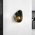 Black and gold marble wall light featuring a circular fixture with gold-toned metal accents and 40w maximum bulb wattage