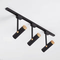 Black DecorBites Nordic tubular metallic spotlight with three cylindrical heads and natural wood caps for track lighting