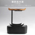 Black ceramic water fountain with wood roof living room decor