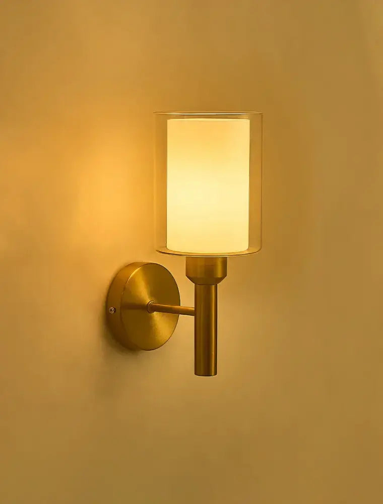 Classic brass glass wall sconce with frosted shade for bedroom