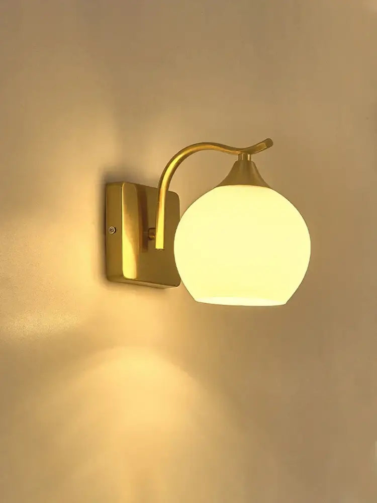 Classic brass glass wall sconce with frosted shade for bedroom