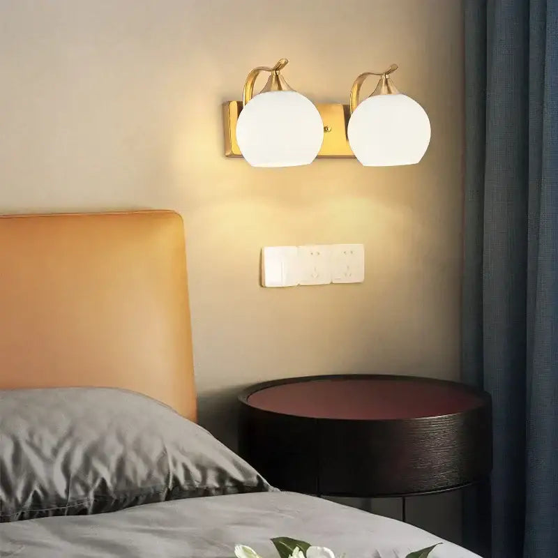 Classic brass glass wall sconce with frosted shade for bedroom