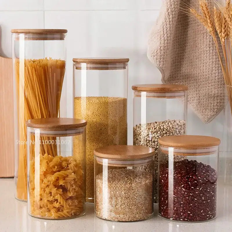 Clear glass storage jars with bamboo lids for kitchen organization