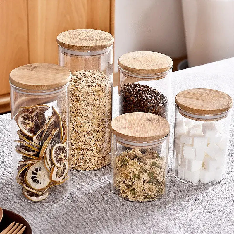 Clear glass storage jars with bamboo lids for kitchen organization