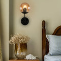 Contemporary black and amber globe glass wall light bedroom