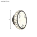 Contemporary black circular wall light with clear crystal trim and decorative swirl patterns on white diffuser for bedroom