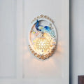Contemporary blue and white peacock wall sconce with gold floral accents and crystal ball for living room living space