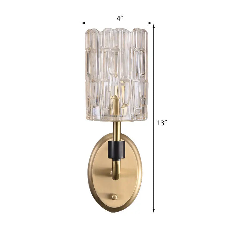 Contemporary brass bedside wall sconce with clear crystal shade bedroom