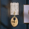 Contemporary brass bedside wall sconce with clear crystal shade bedroom