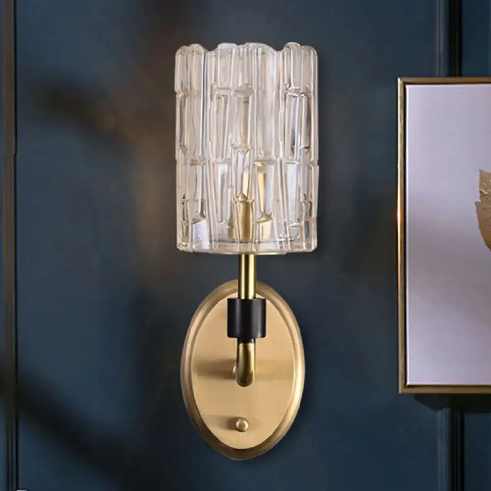 Contemporary brass bedside wall sconce with clear crystal shade bedroom