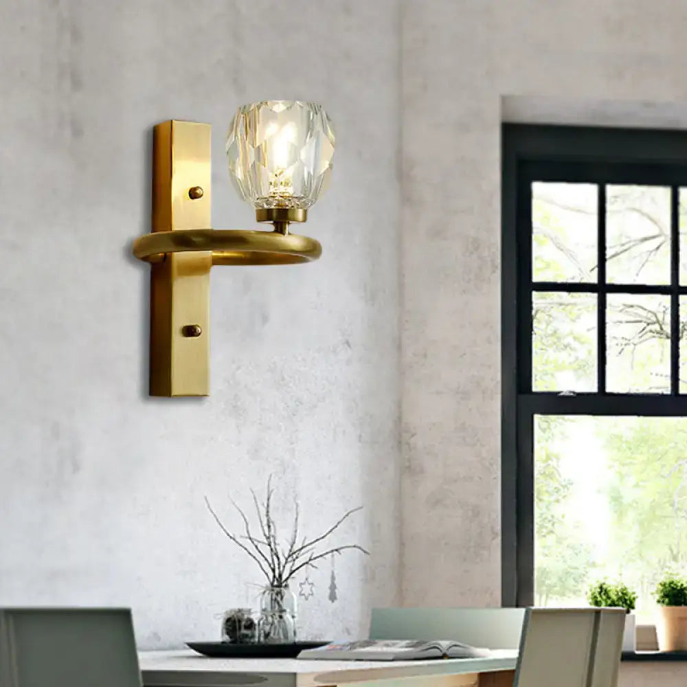 Contemporary brass wall sconce with global crystal shade dining room