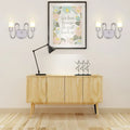Contemporary silver curved wall sconce with two upward lights and central circular accent for bedroom lighting