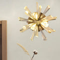 Contemporary gold crystal sputnik wall sconce with radiant faceted sunburst arms and standard bulb base inches tall