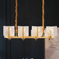 Contemporary gold linear chandelier light fixture with twisted rope chains and five rectangular square glass panels