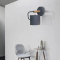 Contemporary gray metal wall light with cylindrical shade and wooden handle for 110v-120v or 220v-240v bedroom use