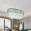 Contemporary silver oval crystal drip pendant light with sleek black frame and cascading clear faceted crystals for dining room