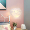 Contemporary white feather wall lamp with soft texture and warm glow for bedroom sconce lighting