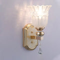 Country gold frosted glass floral wall sconce lamp with gold finish and dangling crystal teardrop for bedroom lighting