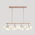 Modern rose gold acrylic island lighting fixture with delicate branch-like arms and teardrop glass bulbs for dining rooms