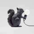 Black resin artistic squirrel night table lamp holding clear bulb compatible with 220v-240v and 110v-120v power