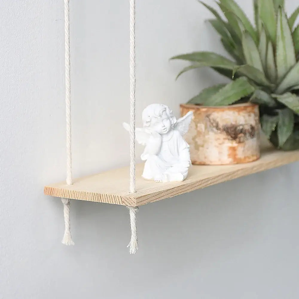 DecorBites™ boho macrame wall shelf featuring a minimalist wooden shelf with white rope and rustic home decor accents
