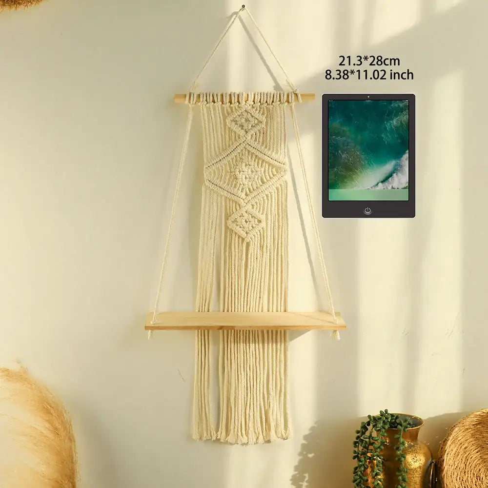Cream-colored macrame wall shelf with intricate knotwork and fringe by decorbites™ for boho home decor hanging shelf