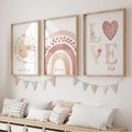 Three framed watercolor boho rainbow sunshine nursery posters in pastel pink beige and soft brown hues with floral details
