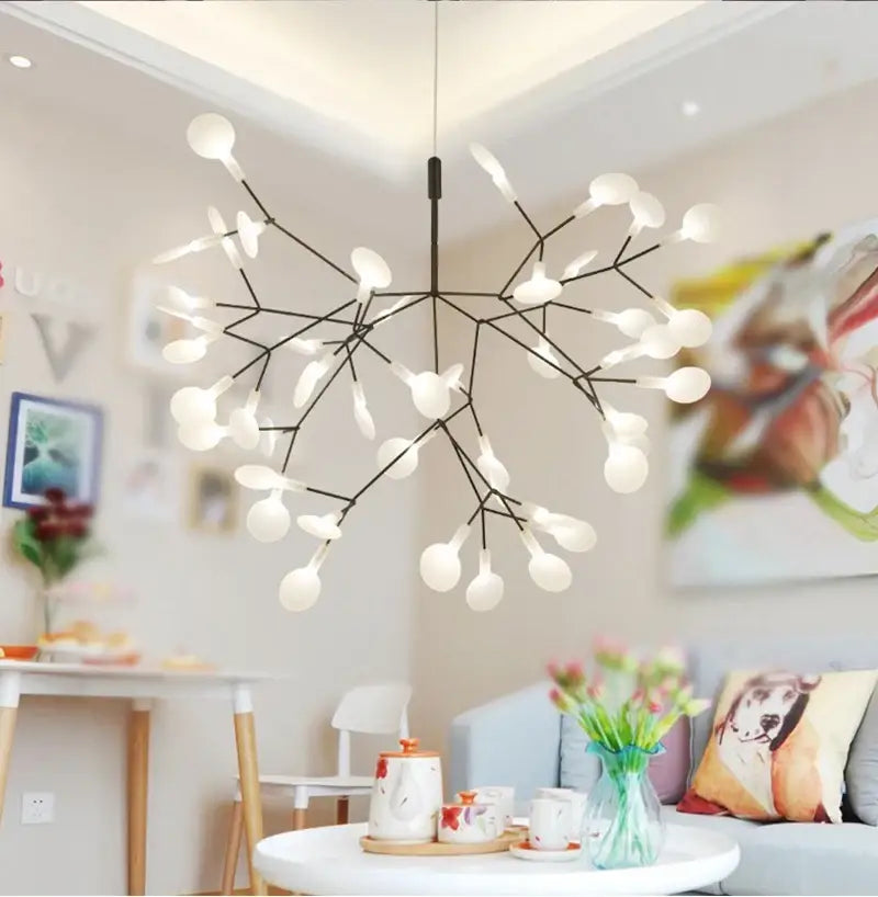 Modern black metal chandelier with branch design and frosted glass globes in rose gold black finish by DecorBites
