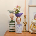 Decorbites™ ceramic vase set featuring two stylized ceramic vases in light blue and purple for home decor