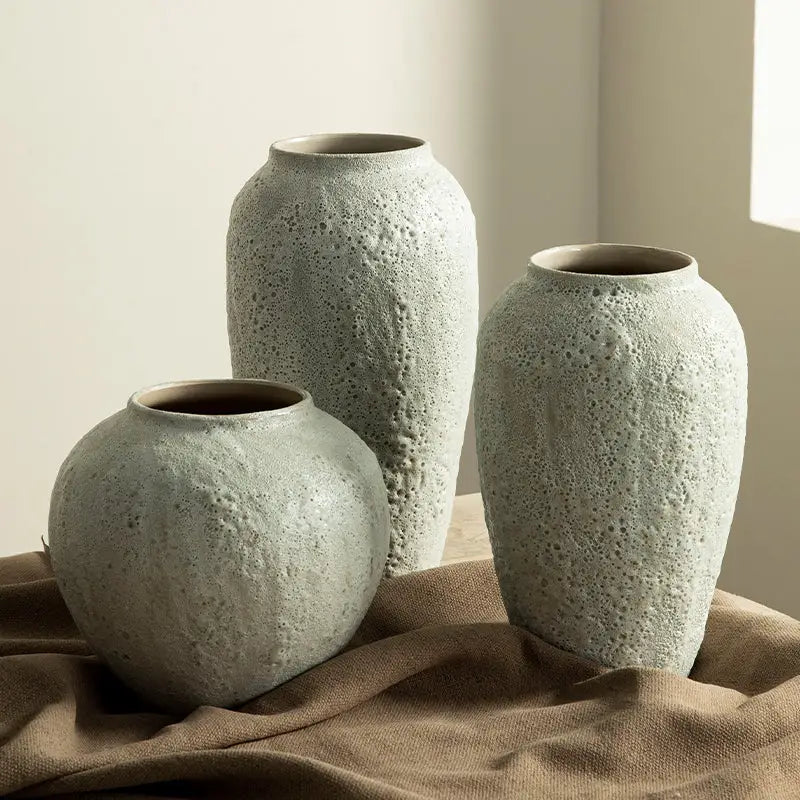 Three matte-finished light gray textured ceramic vases with rounded shapes in chinese style for home decor by DecorBites
