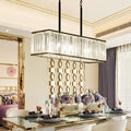 Rectangular clear crystal island pendant light with black metal frame and hanging chains for modern dining rooms