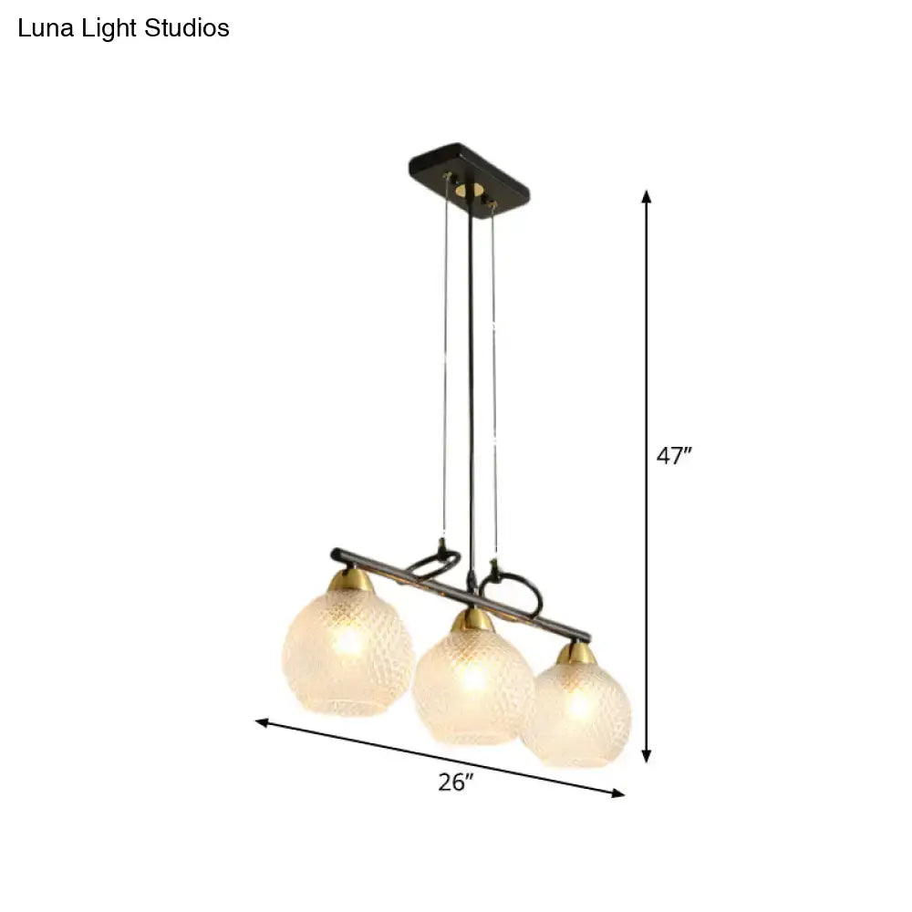 A modern DecorBites contemporary black three-light pendant with frosted and clear prismatic glass for dining hall