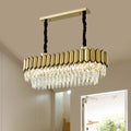 Gold-toned rectangular oval island light with faceted crystal droplets on a sleek metal frame and led bulbs
