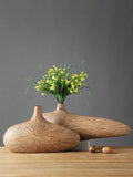 Two sleek light-brown wooden vases with radial grooves showcasing decorbites contemporary resin vase design