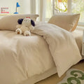 Cream-colored soft textured cotton bedding set with duvet cover and plush stuffed dog toy on top by decorbites