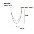 Minimalist u-shaped wall lamp with two slender metallic arms and 7w led bulb featuring flexible leather belt design
