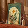 A framed emerald green lily wall art print featuring stylized white flowers and foliage in a light wood frame